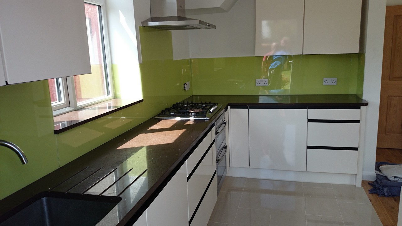Lime green glass kitchen splashback installed by Hither Green glaziers